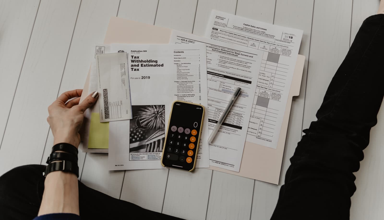 Person reviewing financial documents at a desk